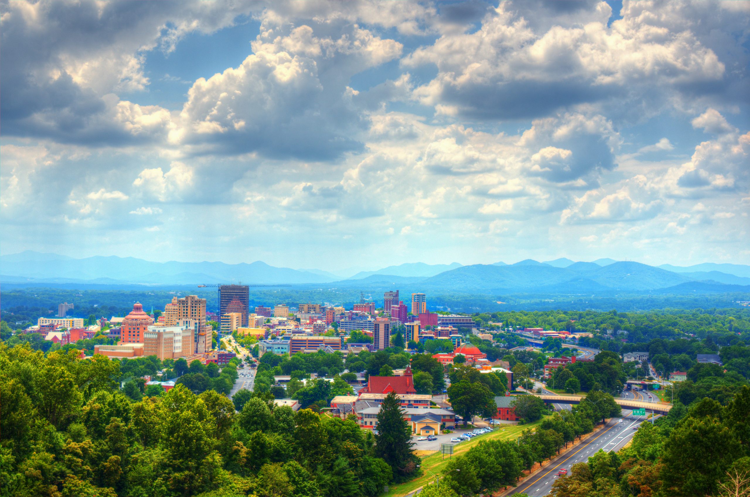 Asheville, North Carolina skyline nestled in the Blue Ridge Mountains.